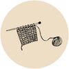 Knitting needle with yarn and partially knitted fabric on a beige background.
