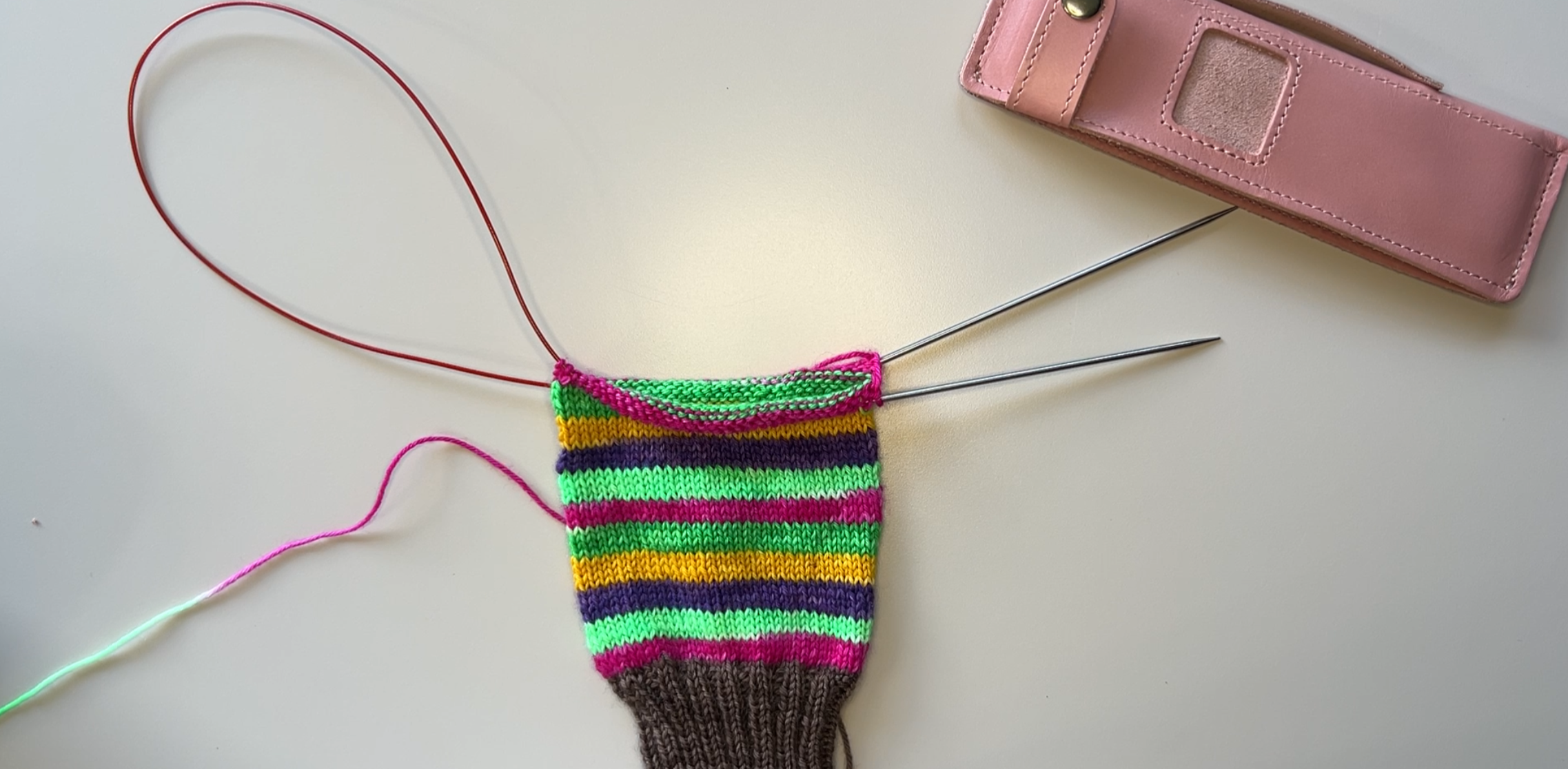 The start of a self striping sock on the Magic Loop.