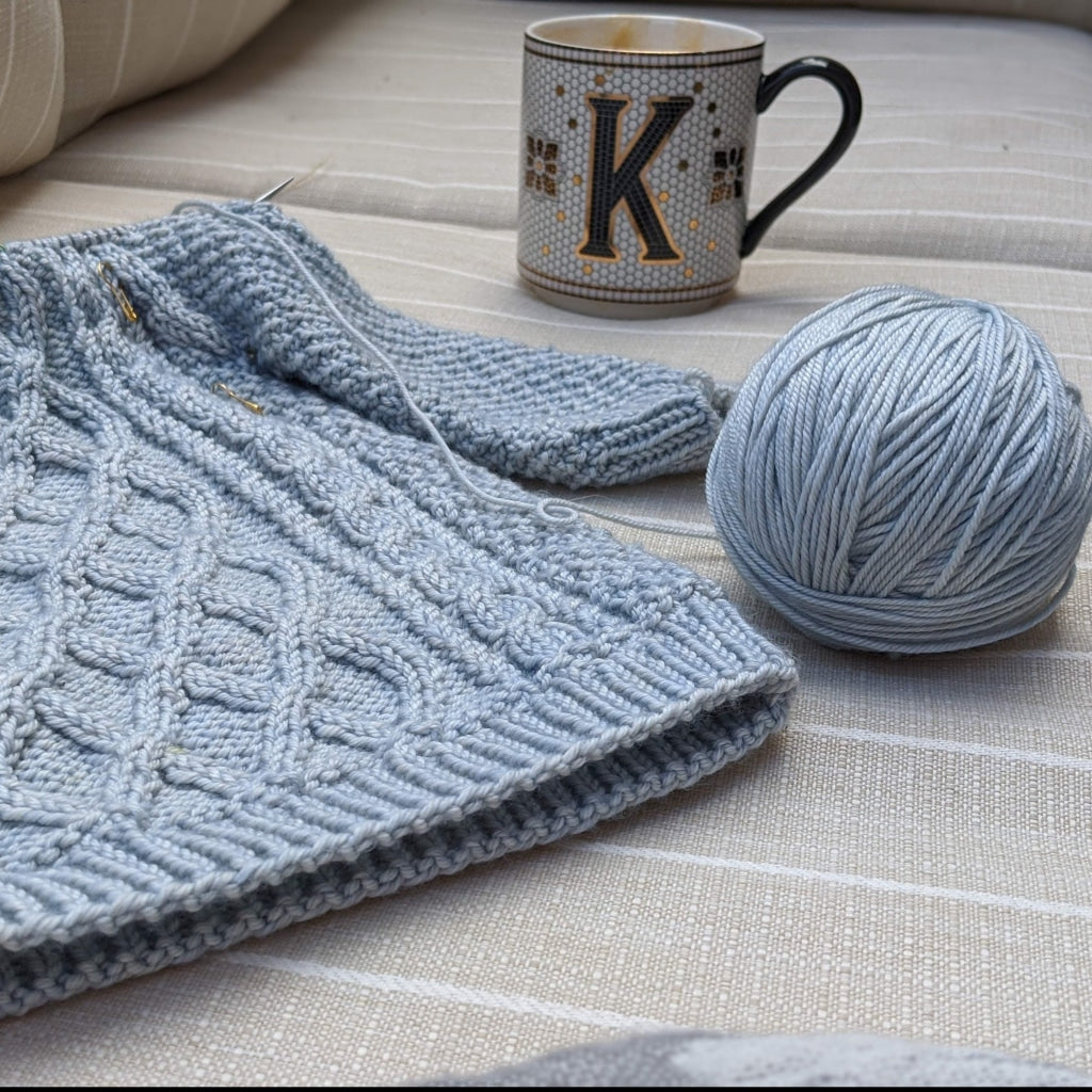 Worsted wool next to cable knit sweater.