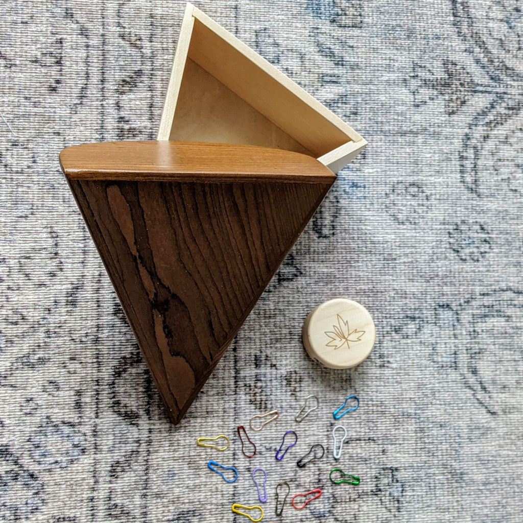 unique gift box for knitter featuring magnetic handmade wooden box shaped like a slice of cake with colourful stitch marker 'sprinkles' that stick to the lid and maple wood tape measure