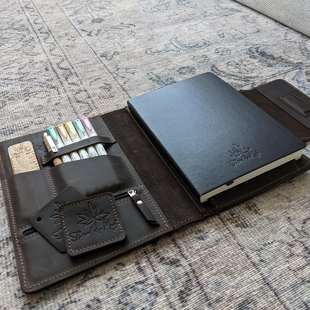 brown leather folio for leuchtturm notebook with zebra highlighters, needle gauge ruler and bamboo pen